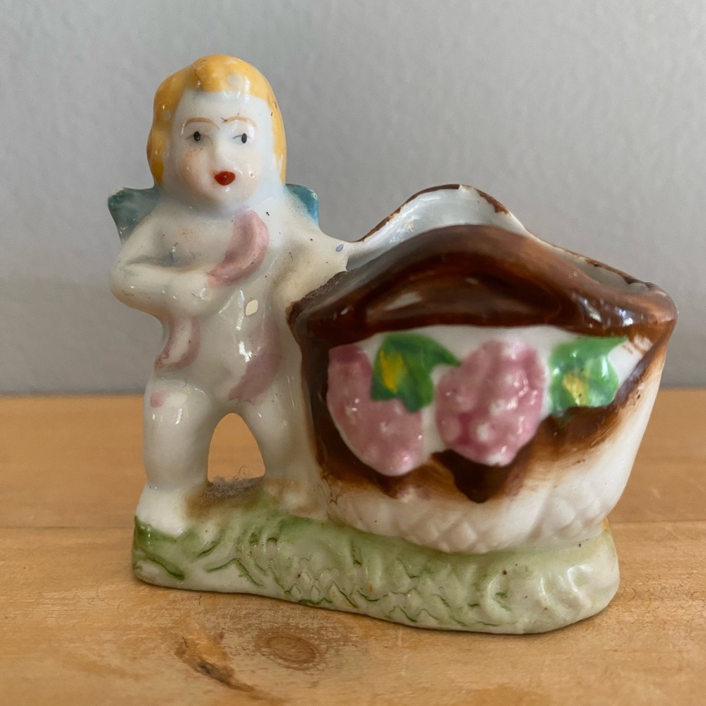 vintage Occupied Japan porcelain cherub toothpick holder with painted flowers.